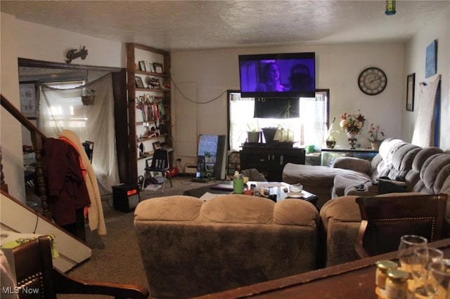 living room featuring a textured ceiling, a wealth of natural light, and carpet floors