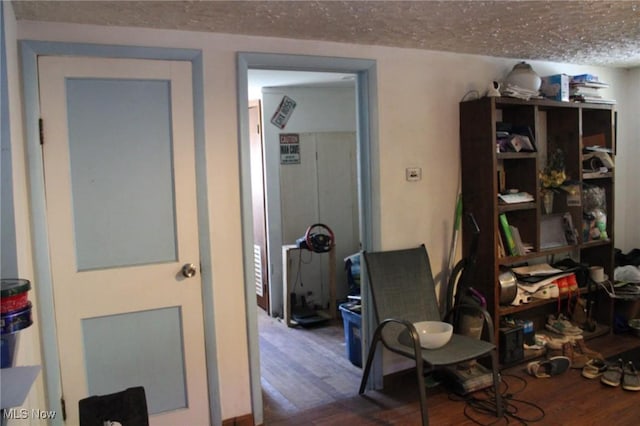 office area with a textured ceiling and hardwood / wood-style floors