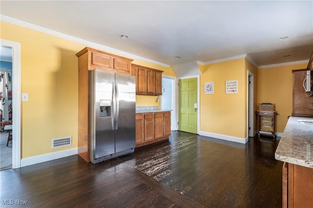 kitchen featuring appliances with stainless steel finishes, dark hardwood / wood-style flooring, and crown molding