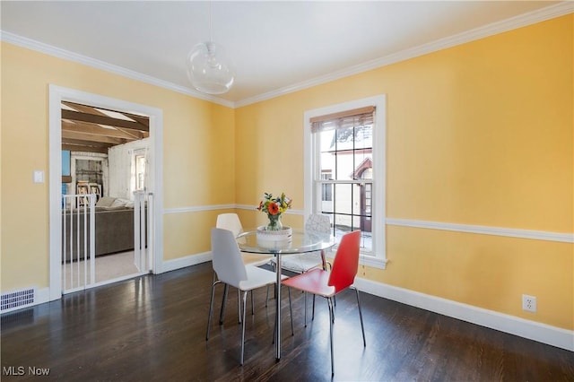 dining space with crown molding, a wealth of natural light, and dark hardwood / wood-style floors