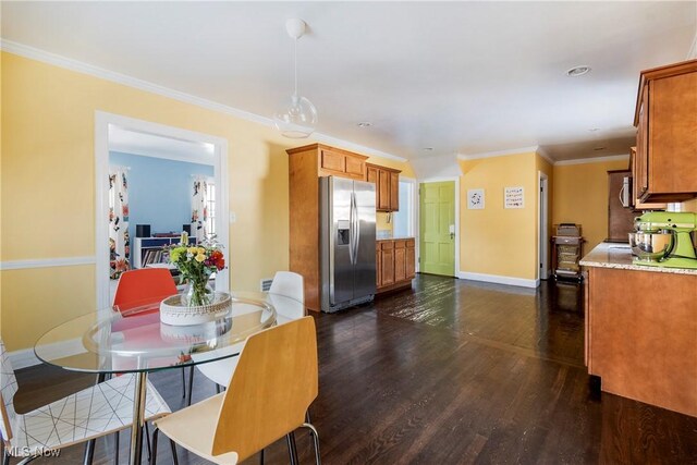 dining space with crown molding and dark hardwood / wood-style flooring