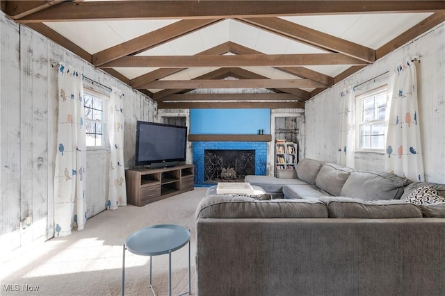 living room with a wealth of natural light, vaulted ceiling with beams, and carpet flooring