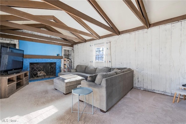 carpeted living room with beam ceiling and high vaulted ceiling