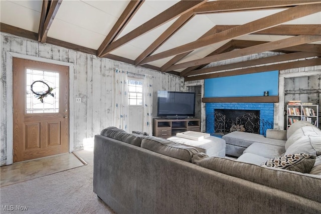 carpeted living room with lofted ceiling with beams