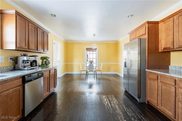 kitchen featuring light stone countertops, decorative light fixtures, ornamental molding, and appliances with stainless steel finishes