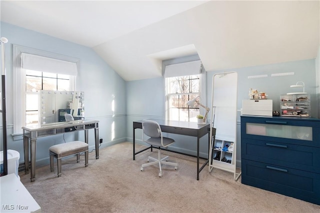 carpeted home office with vaulted ceiling and plenty of natural light