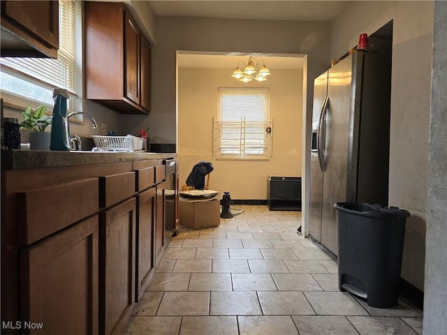 kitchen featuring stainless steel fridge and a chandelier