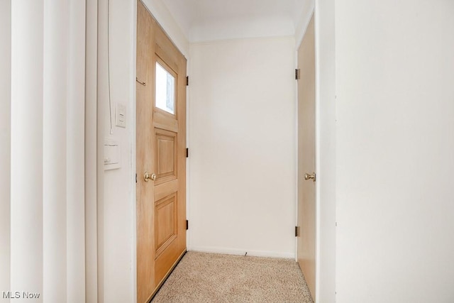 doorway with light colored carpet