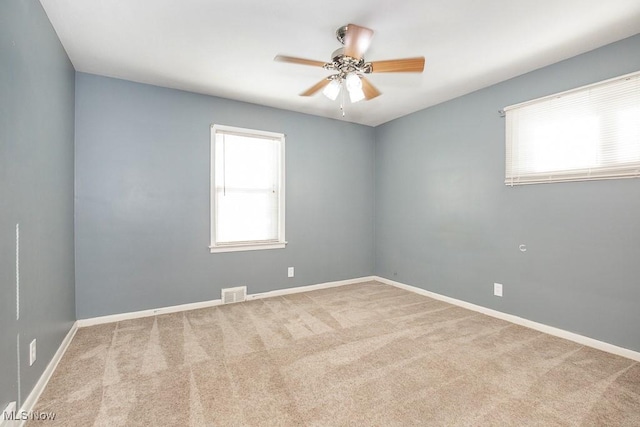 spare room featuring carpet floors and ceiling fan