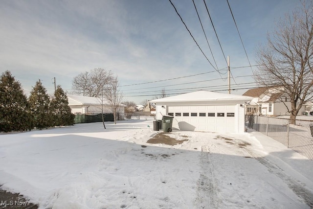 view of front of home with a garage and an outbuilding