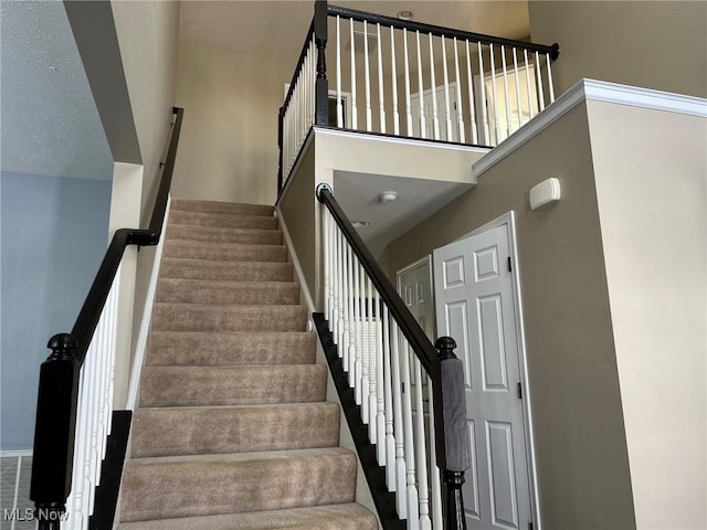 staircase with a high ceiling