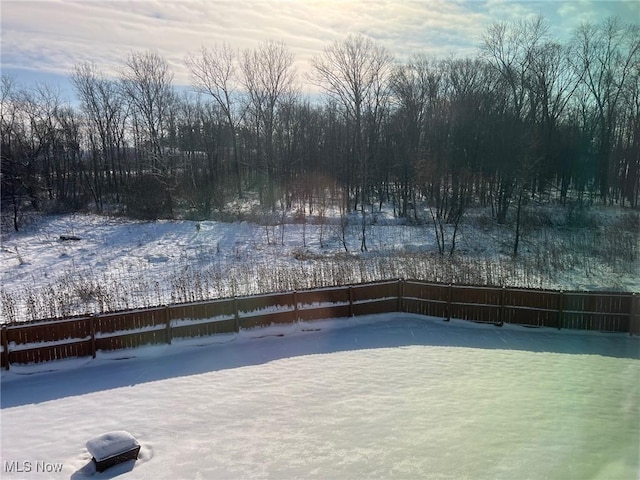 snow covered patio with fence