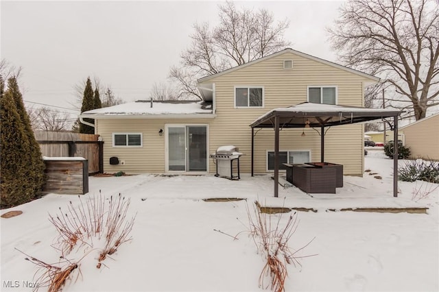 snow covered house featuring a gazebo