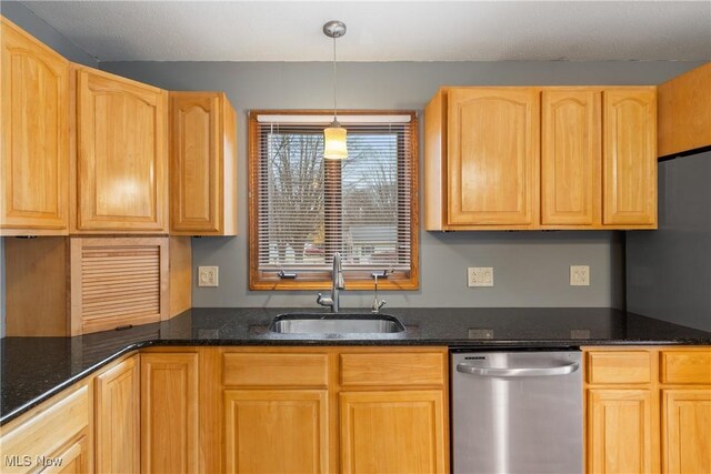 kitchen with pendant lighting, sink, dishwasher, dark stone counters, and light brown cabinets