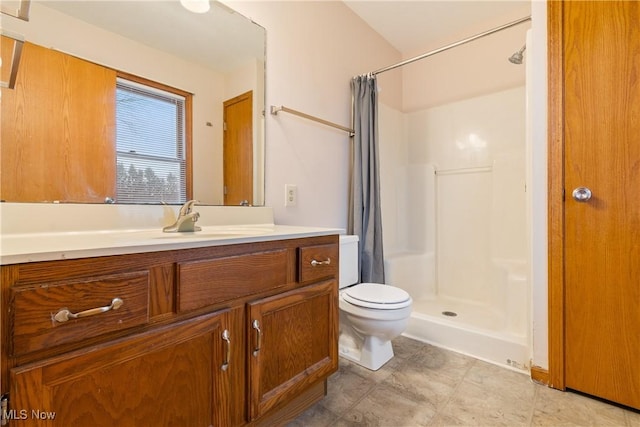 bathroom with vanity, toilet, and curtained shower