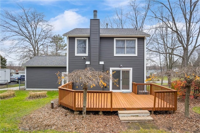 rear view of house featuring a wooden deck