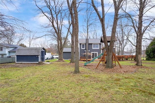 view of yard with a storage unit and a playground