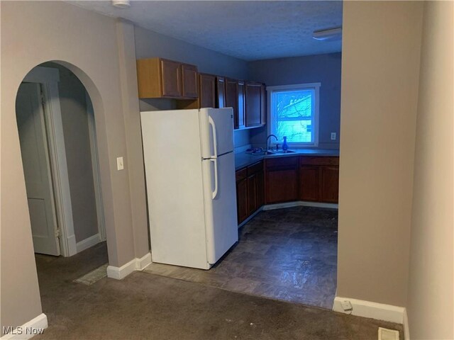 kitchen featuring sink and white fridge