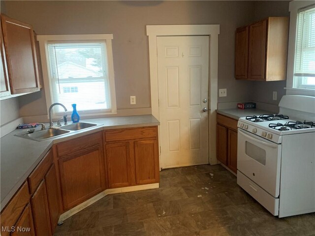 kitchen featuring sink and white range with gas cooktop