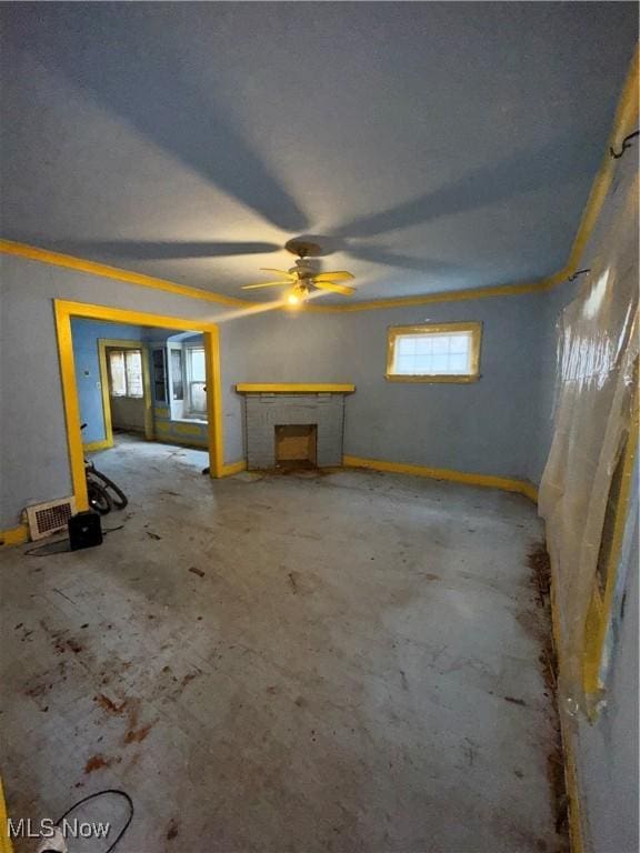 unfurnished living room featuring ceiling fan