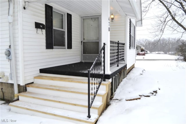 view of snow covered property entrance