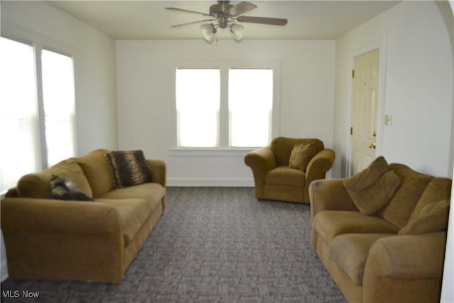 living room featuring ceiling fan and carpet