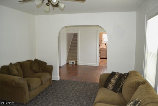 living room featuring sink, ceiling fan, and dark hardwood / wood-style floors