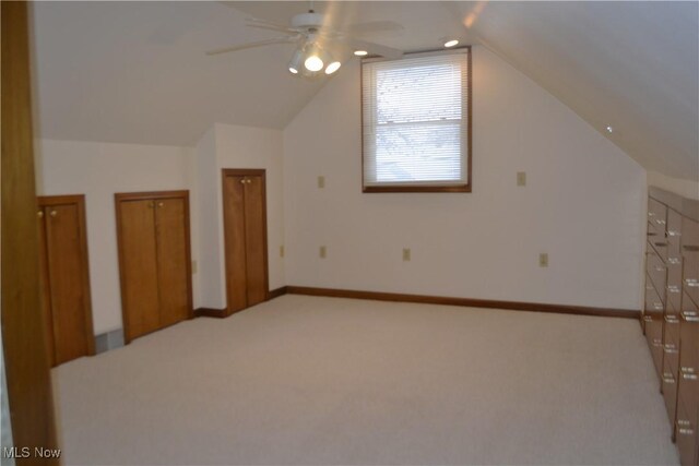 additional living space featuring lofted ceiling, ceiling fan, and light carpet