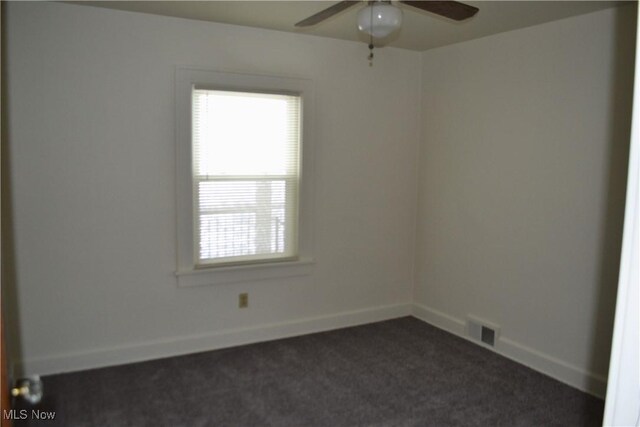 carpeted spare room featuring ceiling fan