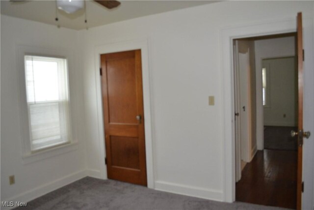 unfurnished bedroom with ceiling fan and carpet flooring