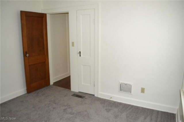 unfurnished room featuring light colored carpet