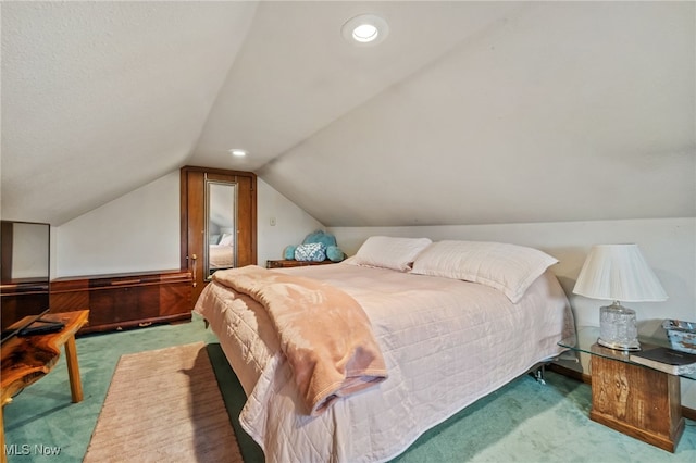 bedroom featuring carpet floors and lofted ceiling