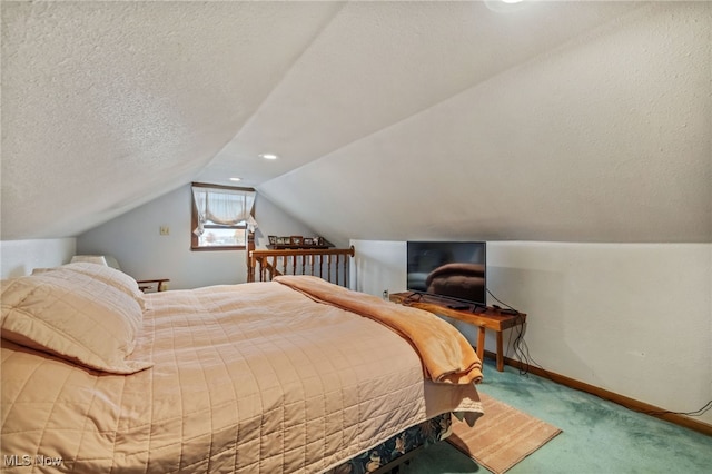 bedroom with lofted ceiling, a textured ceiling, and carpet flooring