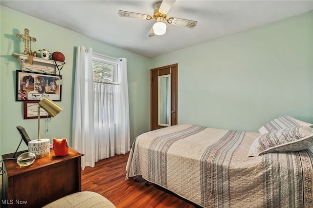 bedroom with ceiling fan and dark wood-type flooring