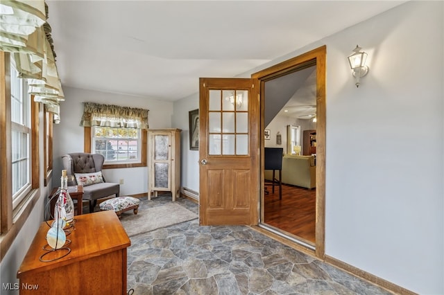 sitting room featuring ceiling fan and baseboard heating