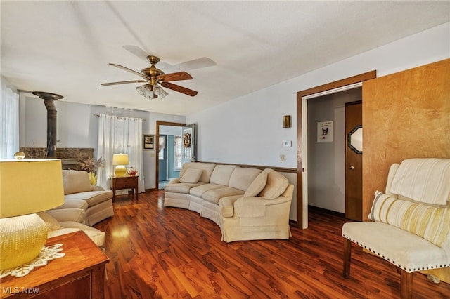 living room featuring ceiling fan and dark hardwood / wood-style floors