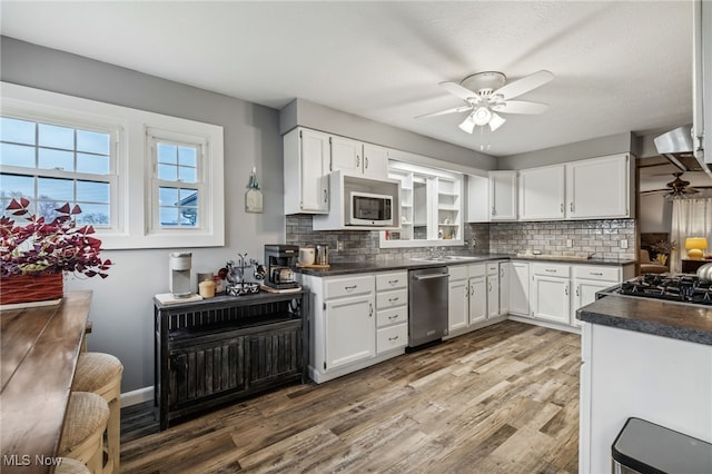 kitchen featuring white cabinetry, ceiling fan, tasteful backsplash, and appliances with stainless steel finishes