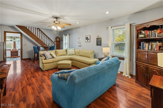 living room with ceiling fan and dark hardwood / wood-style floors