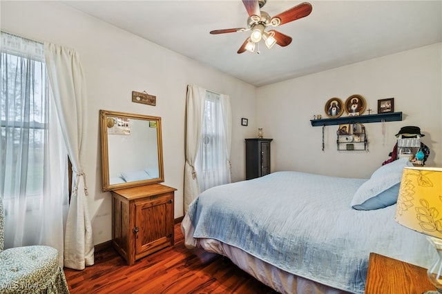 bedroom with dark wood-type flooring and ceiling fan