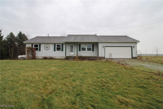 single story home with a front yard and a garage