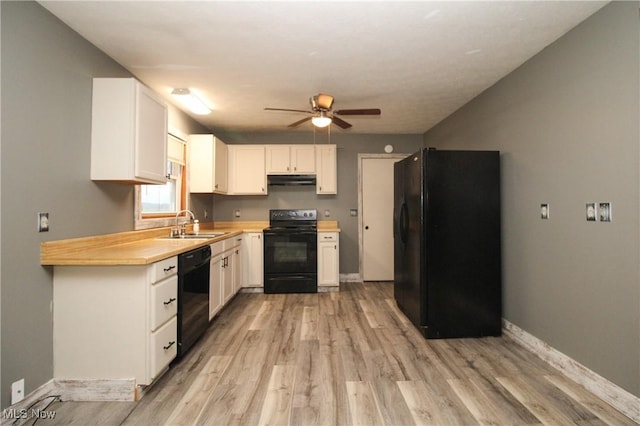 kitchen featuring black appliances, light wood-type flooring, white cabinets, ceiling fan, and sink