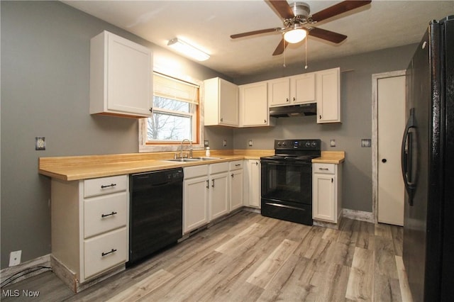 kitchen featuring sink, white cabinets, and black appliances