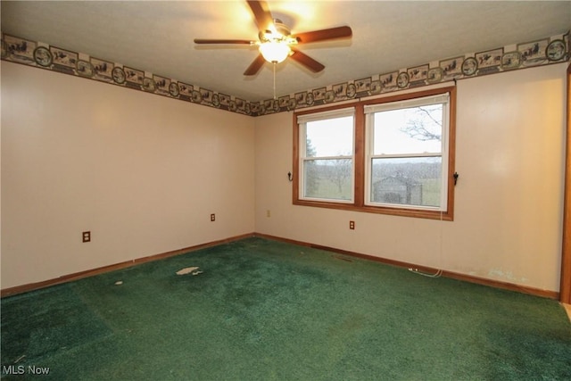 carpeted spare room featuring ceiling fan