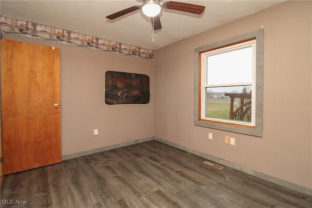 unfurnished room with ceiling fan and dark hardwood / wood-style floors