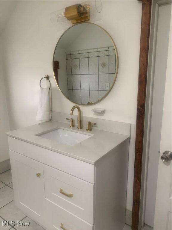 bathroom featuring tile patterned flooring and vanity