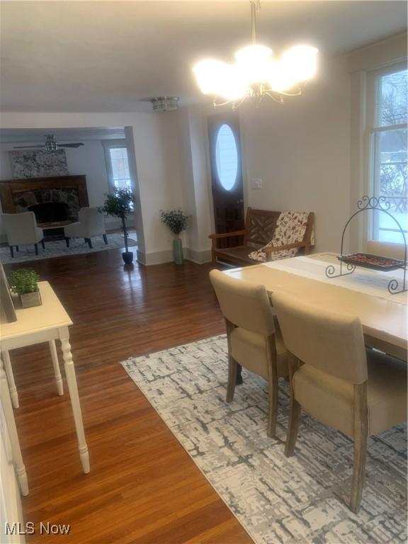 dining area with an inviting chandelier and dark hardwood / wood-style floors