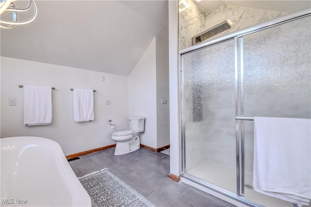 bathroom featuring baseboards, a freestanding bath, a stall shower, and vaulted ceiling