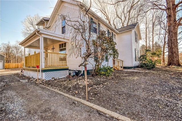 view of home's exterior with an outbuilding and covered porch