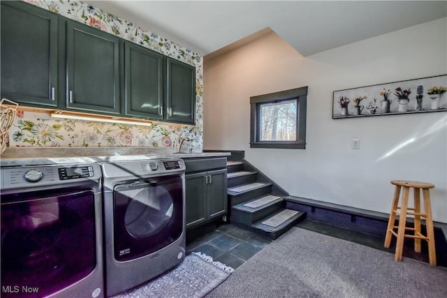 washroom featuring washing machine and clothes dryer and cabinet space