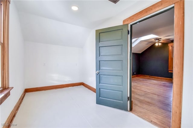 additional living space with baseboards, lofted ceiling, and a ceiling fan